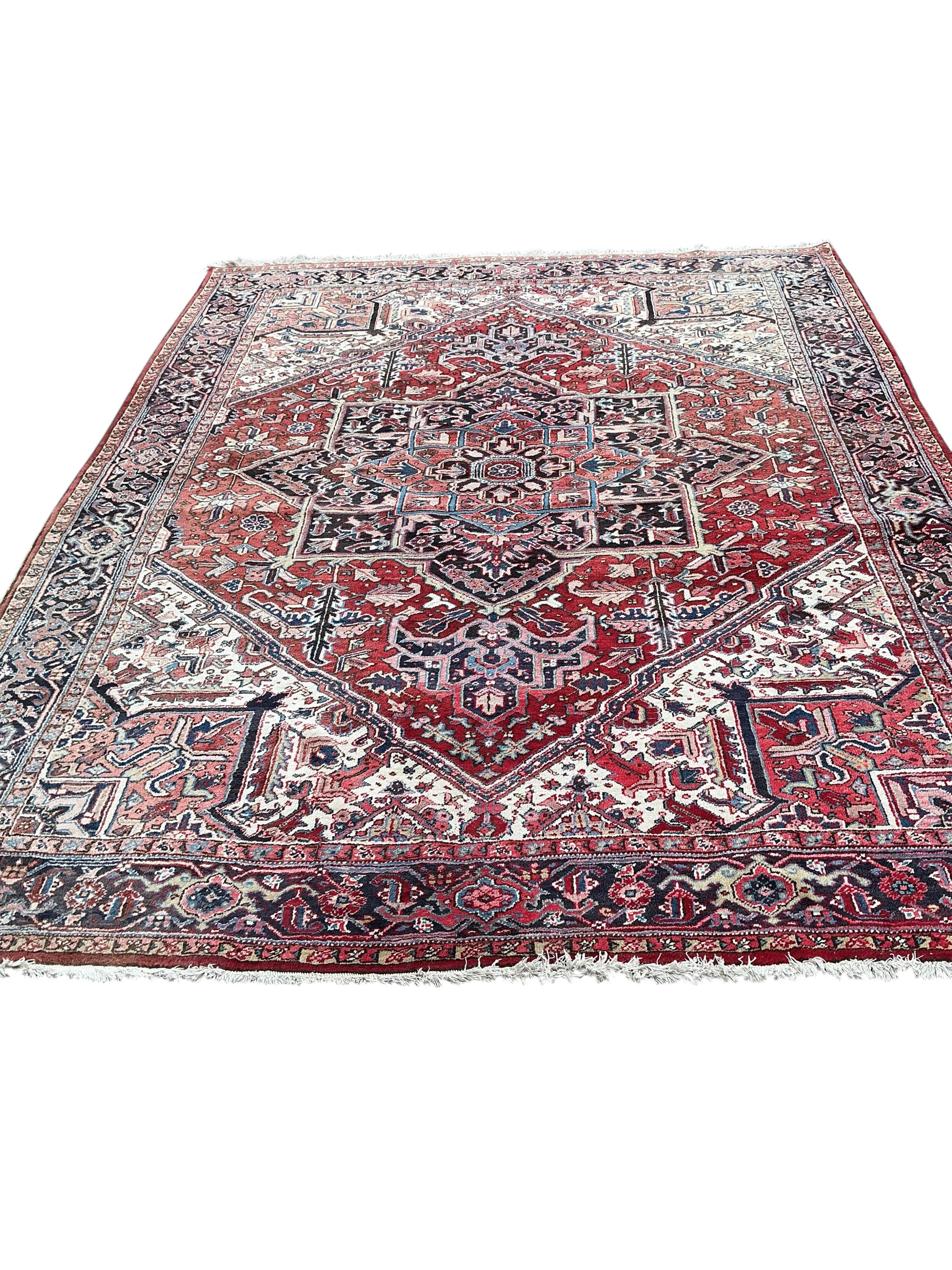 A Heriz red ground carpet, 345 x 265cm